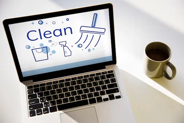 Laptop screen showing "Clean" with cleaning icons and coffee cup
