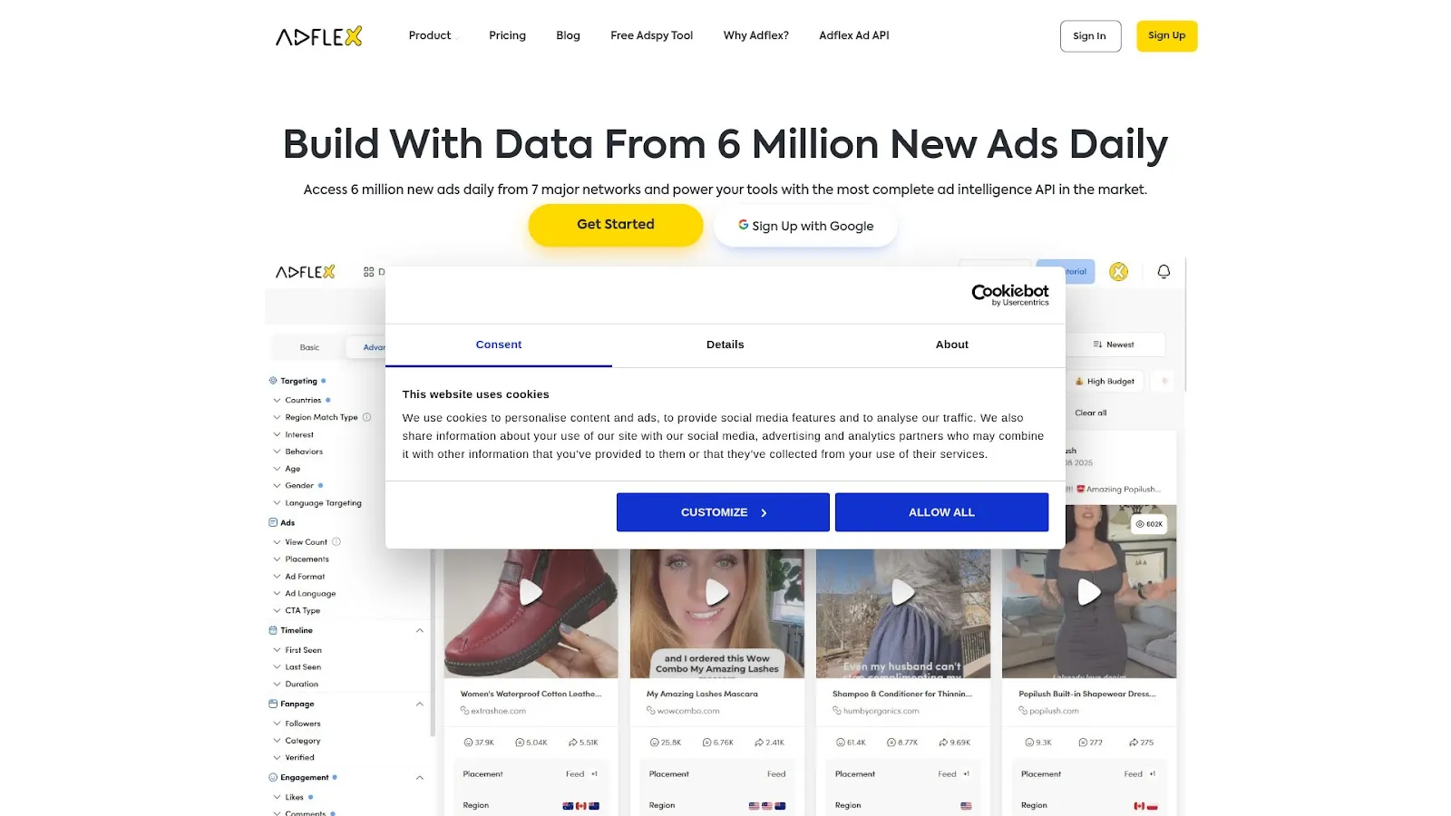 Website homepage displays an ad analytics dashboard obscured by a Cookiebot consent popup and featuring video advertisement thumbnails.